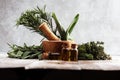 Fresh herbs from the garden and the different types of oils for massage and aromatherapy on table