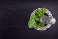 Fresh herbs in a stone mortar on a black wooden table Royalty Free Stock Photo