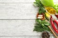 Fresh herbs with vegetables, spices and oil on wooden background Royalty Free Stock Photo