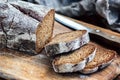 Fresh, home-made bread sliced with cutting knife on rustic table, wooden background Royalty Free Stock Photo