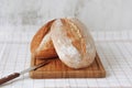 Fresh home-made crusty bread lies on the cutting board