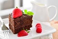 Fresh home made sticky chocolate fudge cake with strawberries and raspberries