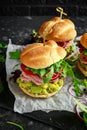 Fresh home sandwich with avocado guacamole, tomatoes, arugula, red onion and ham. Royalty Free Stock Photo