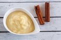 Fresh homemade applesauce, apple puree, mousse, sauce with cinnamon on white wooden table top view Organic vegetarian Royalty Free Stock Photo