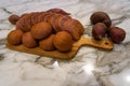 Fresh homemade baked purple japanese sweet potato bread in sliced loaf and buns on wooden cutting board on white marble table top Royalty Free Stock Photo