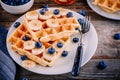 Fresh homemade belgian waffles with blueberries and banana for breakfast Royalty Free Stock Photo