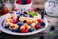 Fresh homemade belgian waffles with blueberries and raspberries for breakfast Royalty Free Stock Photo