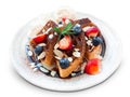 Fresh homemade Belgian waffles with strawberry, blueberry and ice cream topping chocolate sauce and almond slide isolated white Royalty Free Stock Photo