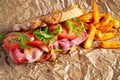 Fresh homemade BLT sandwich on grilled bread with bacon, lettuce, beef tomato, red onions, wild rocket and chips Royalty Free Stock Photo