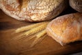 Fresh homemade bread assortment on old cutting board Royalty Free Stock Photo