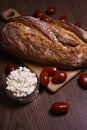 Fresh homemade bread on a cutting board with homemade cheese and fresh tomatoes Royalty Free Stock Photo