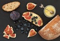 Fresh homemade bread, homemade baking. Blank for sandwich, figs, blueberries, sauce. Top view. Black stone background