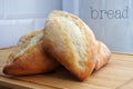 Fresh homemade bread loafs on a wooden cutting board cooling down Royalty Free Stock Photo