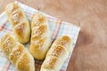 Fresh homemade bread rolls with sesam seed on napkin on wooden t Royalty Free Stock Photo