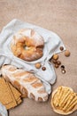 Fresh homemade bread and various pastries on a brown background top view.