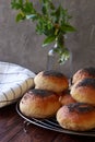 Fresh homemade burger buns with popp yseed, concept of burger and homemade food. Mini challah. Homemade bread on brown and grey ba