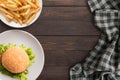 Fresh homemade burger and french fries on wooden table. Top view, Copy space. Royalty Free Stock Photo