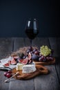 Fresh homemade camembert cheese with fresh fruits and glass of red wine