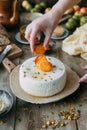 Fresh homemade cheese with dried apricot. Still life with hands, the chef prepares dishes.