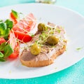 Fresh homemade chicken liver pate on bread and tomatoes salad. Royalty Free Stock Photo