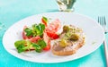 Fresh homemade chicken liver pate on bread and tomatoes salad. Royalty Free Stock Photo