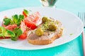 Fresh homemade chicken liver pate on bread and tomatoes salad. Royalty Free Stock Photo