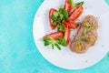 Fresh homemade chicken liver pate on bread and tomatoes salad. Royalty Free Stock Photo