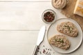 Fresh homemade chicken liver pate with herbs for bread on a white wooden table. A sandwich. top view Royalty Free Stock Photo