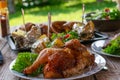 Barbecue chicken with baked potatoes outside Royalty Free Stock Photo