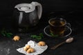 Fresh Homemade Cookies with Mint Tea and One Partly Eaten on Dark Stone Table with Copy Space Horizontal