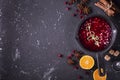 Fresh homemade cranberry sauce in a pan on dark wooden background with scattering of ripe berries. Royalty Free Stock Photo