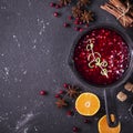 Fresh homemade cranberry sauce in a pan on dark wooden background with scattering of ripe berries. Royalty Free Stock Photo