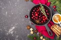 Fresh homemade cranberry sauce in a pan on dark wooden background with scattering of ripe berries. Royalty Free Stock Photo