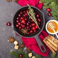 Fresh homemade cranberry sauce in a pan on dark wooden background with scattering of ripe berries. Royalty Free Stock Photo