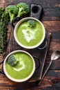 Fresh homemade cream broccoli soup in bowl . Dark Wooden background. Top view