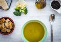 Fresh homemade creamy vegetable soup. Healthy eating - made with cauliflower potatoes, peas, celery and broccoli - wooden table - Royalty Free Stock Photo