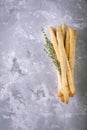 Fresh homemade crispy bread sticks with thyme and sea salt on a gray concrete background herbs Royalty Free Stock Photo