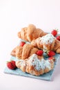Fresh homemade croissants with strawberry and various toppings. Top view. French bakery concept