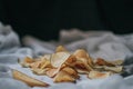 Fresh homemade deep fried crispy potato chips on a wooden tray, top view. Royalty Free Stock Photo