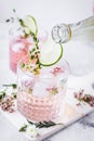 Fresh homemade drink with flowers and lime on kitchen background Royalty Free Stock Photo