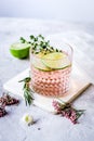 Fresh homemade drink with flowers and lime on kitchen background Royalty Free Stock Photo