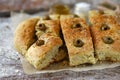 Fresh homemade focaccia with italian herbs. Cooking at home. Traditional italian bread with olives. Royalty Free Stock Photo