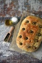 Fresh homemade focaccia with italian herbs. Cooking at home. Traditional italian bread with olives. Royalty Free Stock Photo
