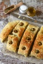 Fresh homemade focaccia with italian herbs. Cooking at home. Traditional italian bread with olives. Royalty Free Stock Photo