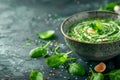 Fresh Homemade Green Spinach Soup with Egg, Cream, and Spices in Rustic Ceramic Bowl on Dark Table Royalty Free Stock Photo