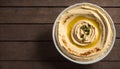Fresh Homemade Hummus in a Bowl on a Wooden Table, Copy Space