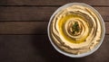 Fresh Homemade Hummus in a Bowl on a Wooden Table, Copy Space