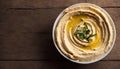 Fresh Homemade Hummus in a Bowl on a Wooden Table, Copy Space