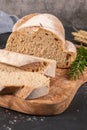 Fresh homemade leavened bread in the sun partially sliced.