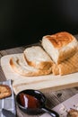 Fresh homemade loafs bread and sliced bread on cutting board with jam strawberry close up on wooden background.Healthy Diet.Prepar Royalty Free Stock Photo